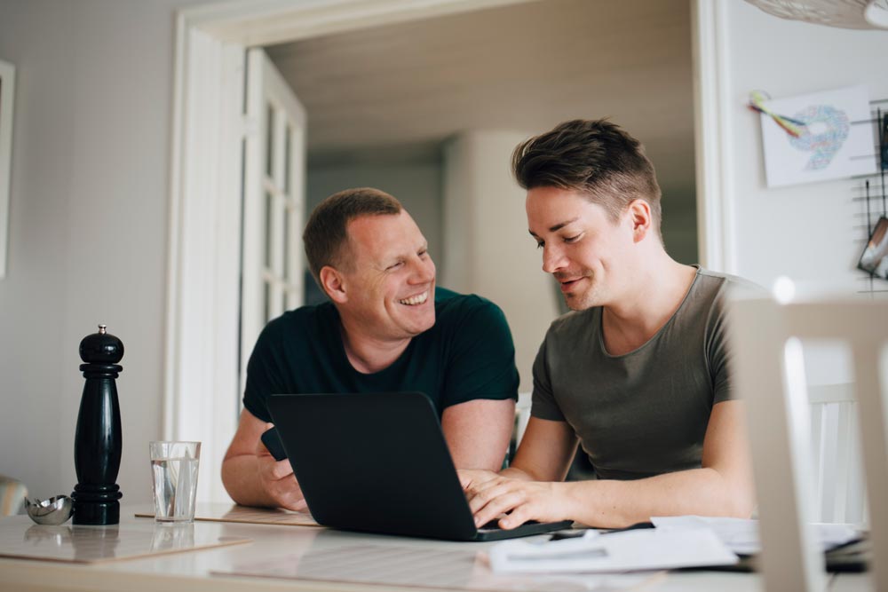 Two men sitting at the computer
